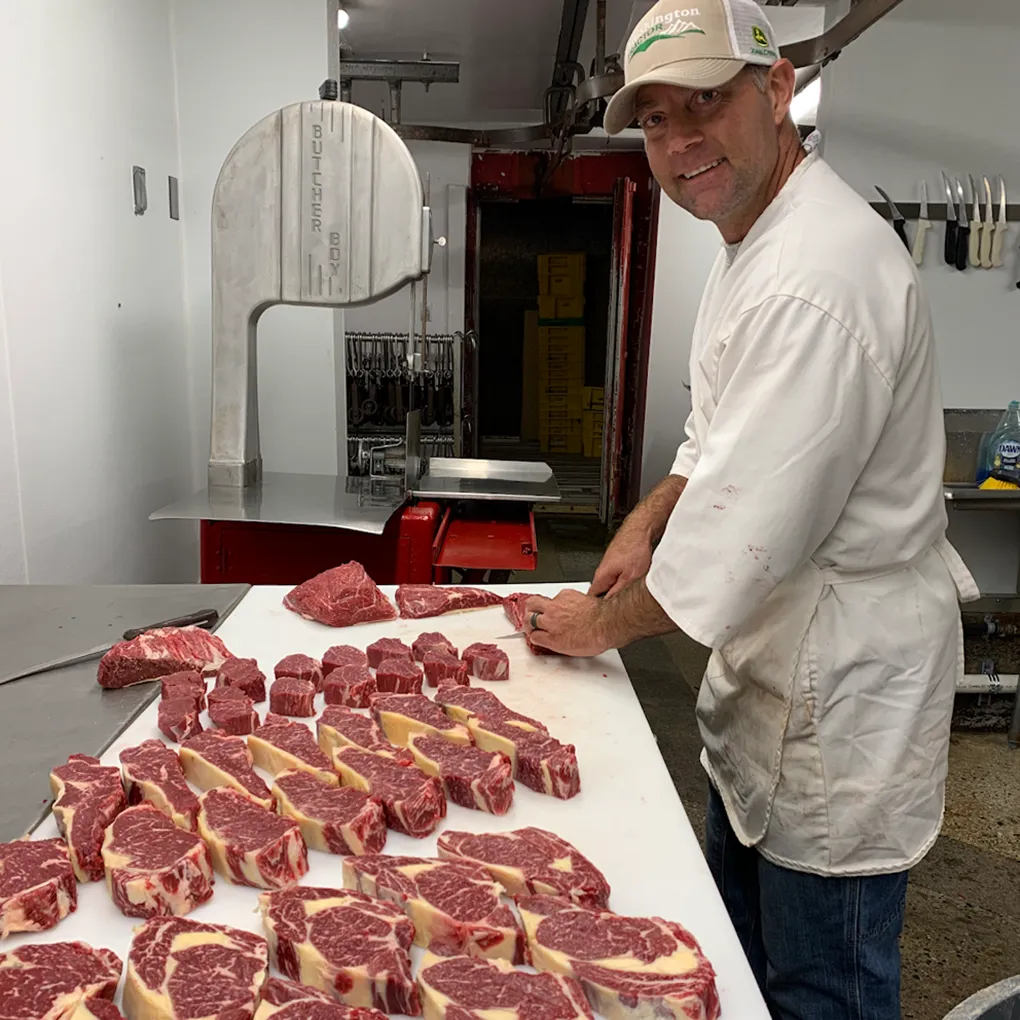 Ernie Klander cutting steaks