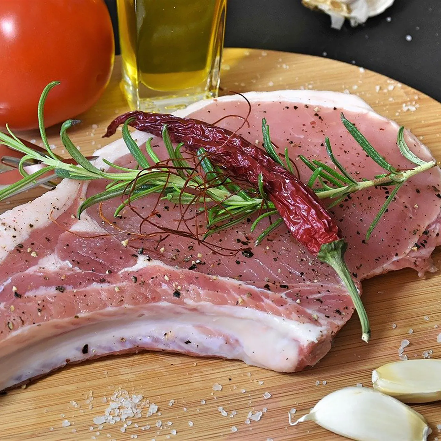 Pork chop on platter prior to cook